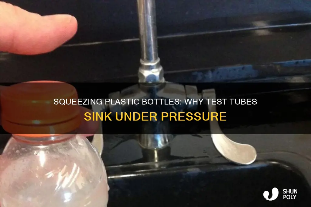 why slightly squeezing plastic bottle causes test tube to sink